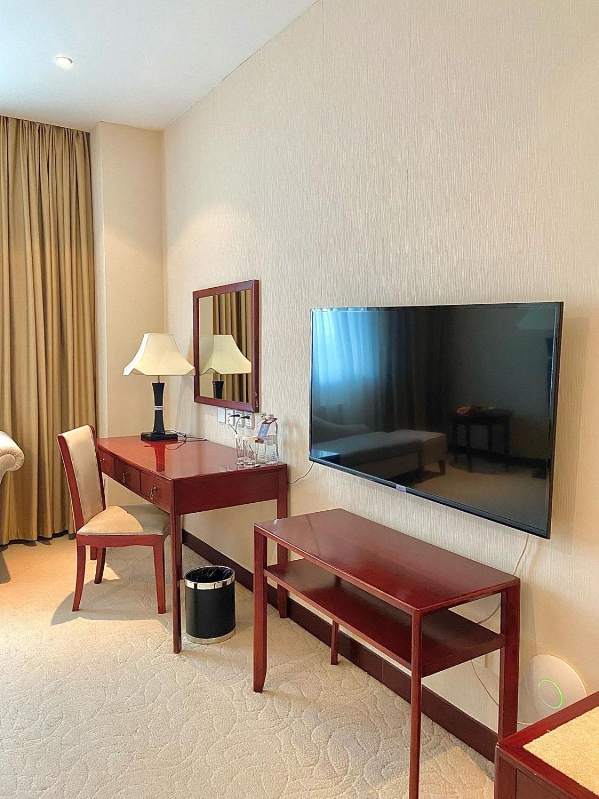 Beijing Palace Soluxe Hotel Astana Екстериор снимка A television set in a hotel room
