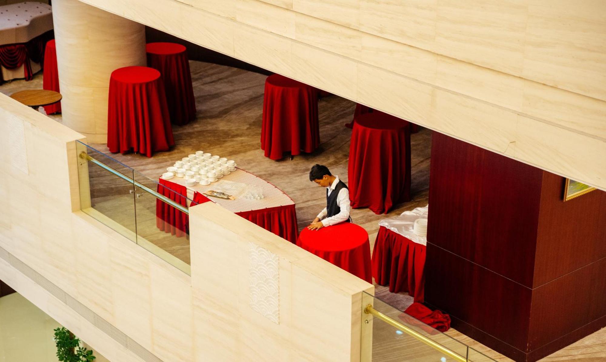 Beijing Palace Soluxe Hotel Astana Екстериор снимка A hotel staff sets up a cocktail reception